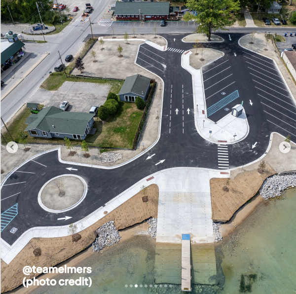 Torch River Bridge Boat Launch — post-renovation aerial showing the one-way loop, trailer parking, ramp lanes, and skid pier