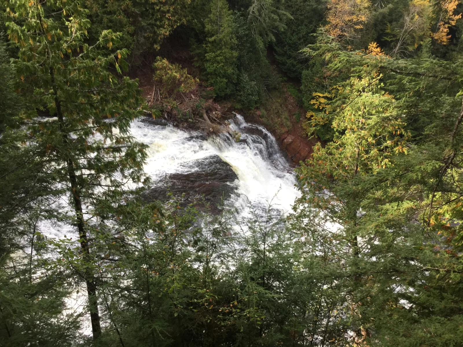 Agate Falls' broad cascade on the Middle Branch Ontonagon River, seen from the old railroad trestle in early fall color.