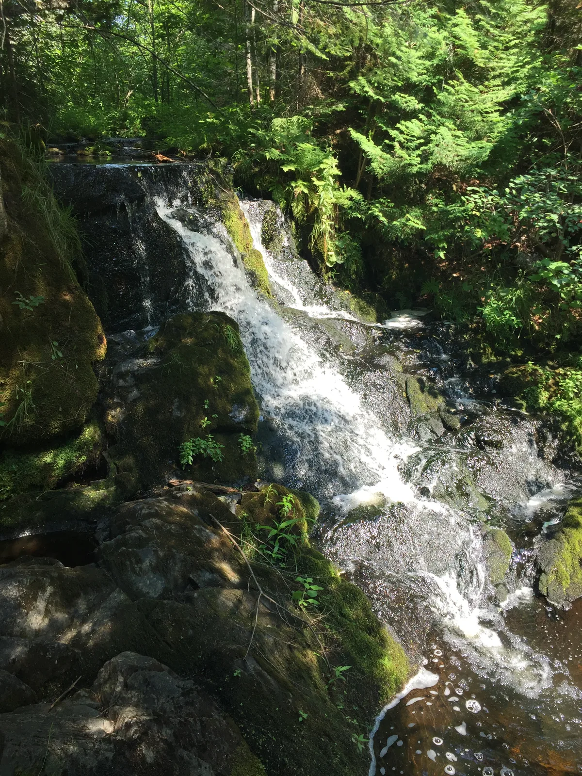 Ogemaw Falls flowing through a tight rocky channel in the Keweenaw Peninsula.