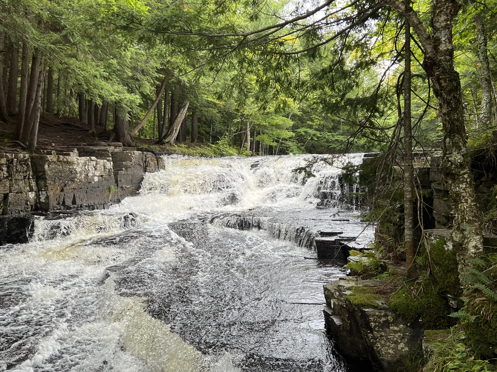 Quartzite Falls flowing over white quartzite ledges in the Upper Peninsula.